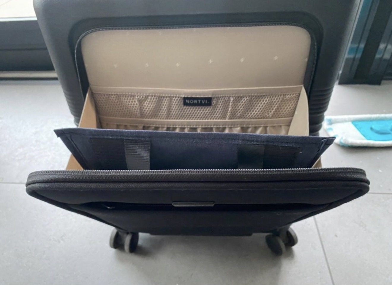 Aero Footrest folded flat inside a carry-on suitcase lid